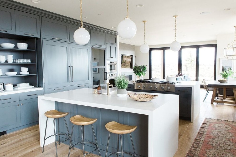 Inspiration for a large eclectic medium tone wood floor open concept kitchen remodel in Salt Lake City with blue cabinets and two islands