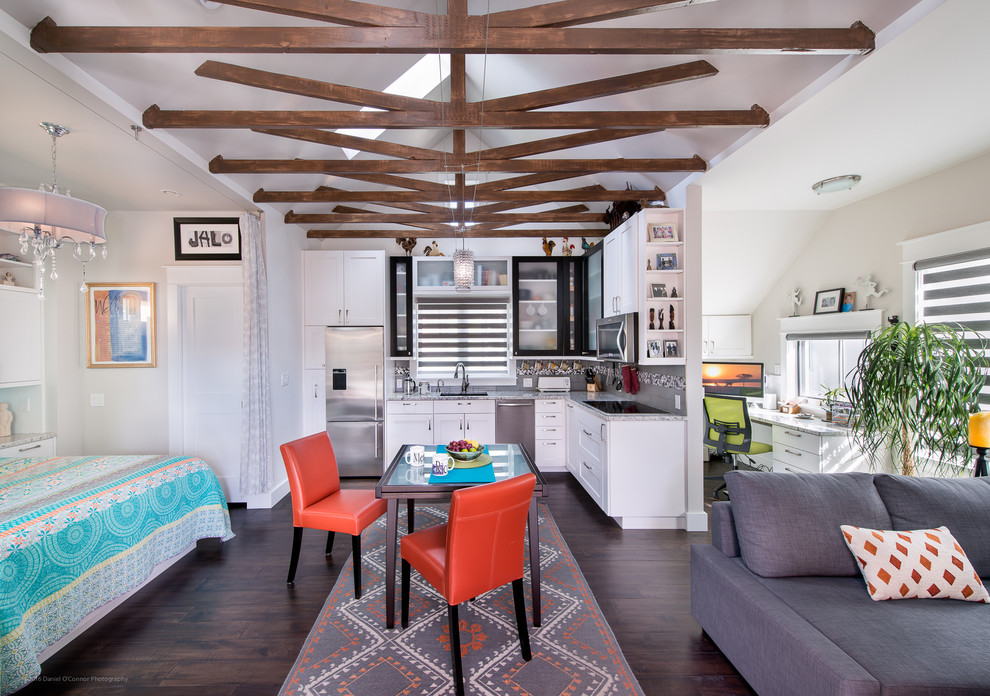 Example of a transitional l-shaped dark wood floor open concept kitchen design in Denver with recessed-panel cabinets, white cabinets, granite countertops, stainless steel appliances, no island, an undermount sink and multicolored backsplash