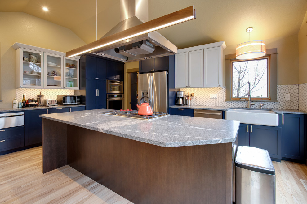 Inspiration for a large contemporary l-shaped light wood floor and beige floor kitchen pantry remodel in Denver with an undermount sink, shaker cabinets, blue cabinets, granite countertops, white backsplash, ceramic backsplash, stainless steel appliances, an island and gray countertops