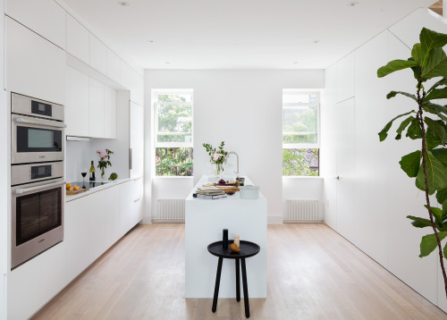 Scandinavian Retreat: Achieve a Scandinavian Look with an All-White Kitchen and Light Wood Floor
