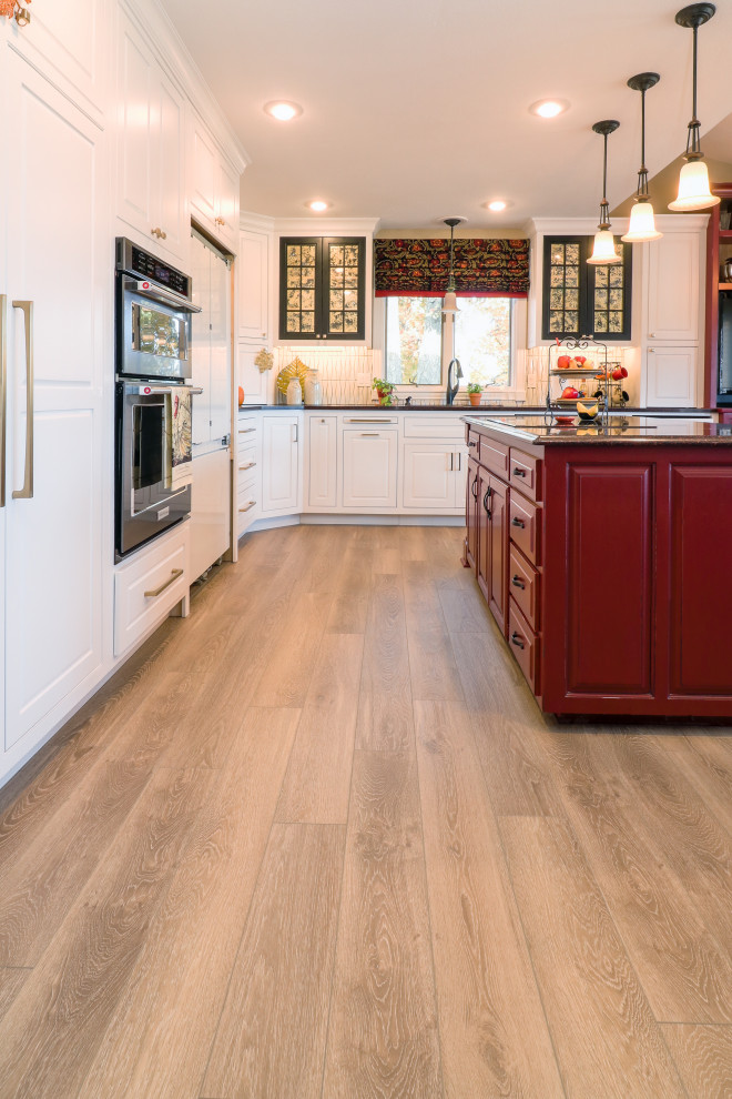 Inspiration for a mid-sized transitional l-shaped vinyl floor and beige floor eat-in kitchen remodel in Other with an undermount sink, shaker cabinets, white cabinets, granite countertops, white backsplash, ceramic backsplash, stainless steel appliances, an island and black countertops