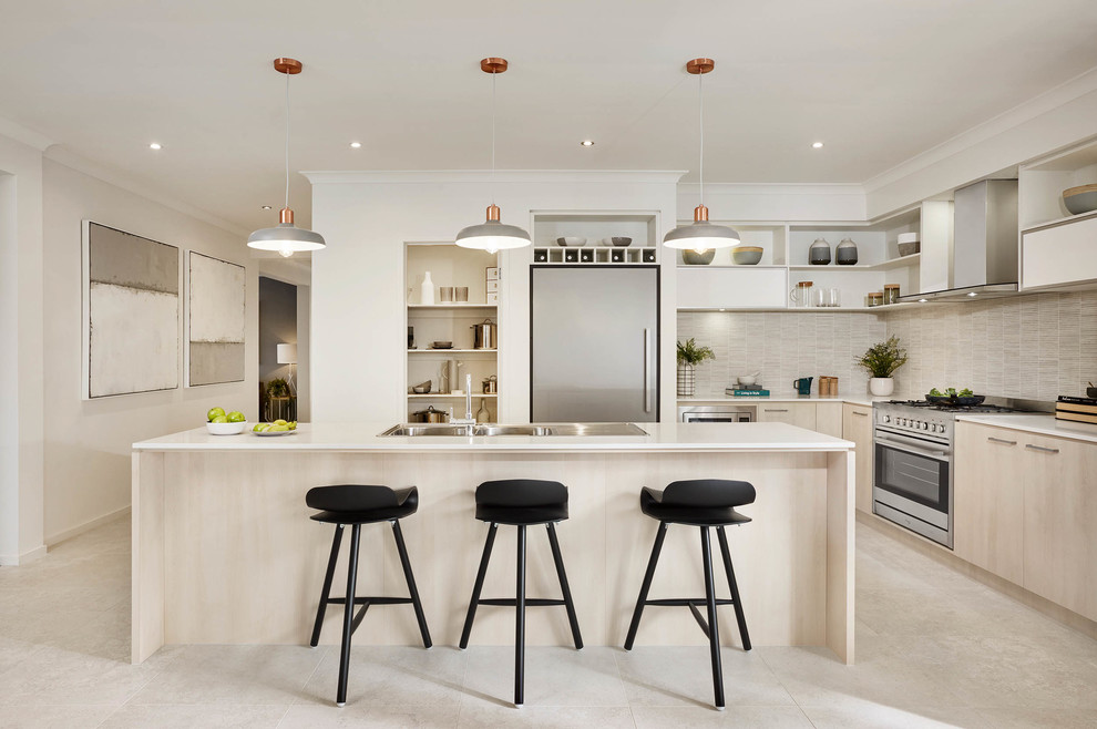 Photo of a contemporary l-shaped kitchen in Melbourne with a double-bowl sink, flat-panel cabinets, light wood cabinets, beige splashback, matchstick tiled splashback, stainless steel appliances and an island.