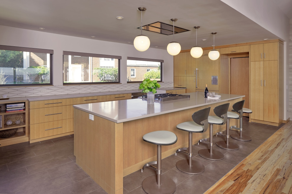 Inspiration for a large 1950s l-shaped porcelain tile and brown floor eat-in kitchen remodel in Other with a farmhouse sink, flat-panel cabinets, light wood cabinets, quartz countertops, beige backsplash, ceramic backsplash, paneled appliances, an island and beige countertops
