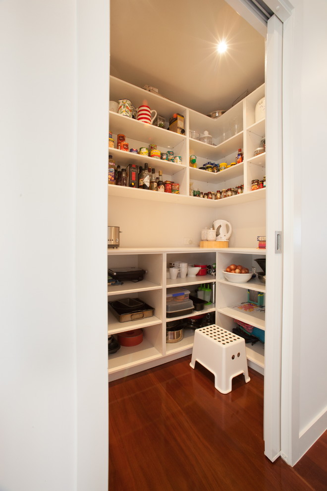 Medium sized contemporary u-shaped kitchen pantry in Brisbane with flat-panel cabinets, white cabinets, concrete worktops, white splashback, dark hardwood flooring and no island.