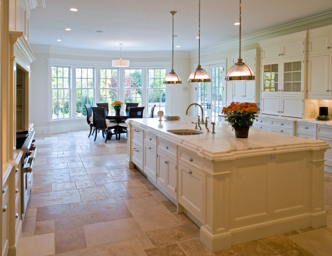 Eat-in kitchen - large traditional galley ceramic tile eat-in kitchen idea in New York with an undermount sink, white cabinets, marble countertops, white backsplash, stainless steel appliances and an island