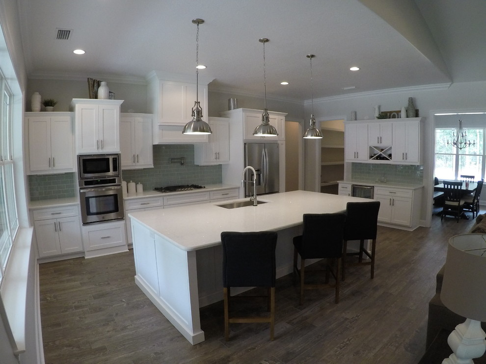 Eat-in kitchen - mid-sized craftsman light wood floor and gray floor eat-in kitchen idea in Miami with an undermount sink, shaker cabinets, white cabinets, quartz countertops, gray backsplash, glass tile backsplash, stainless steel appliances, an island and white countertops