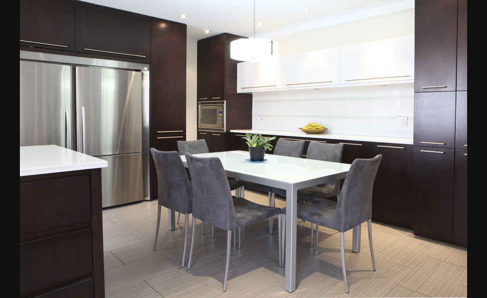 Mid-sized minimalist l-shaped porcelain tile eat-in kitchen photo in Montreal with an undermount sink, flat-panel cabinets, dark wood cabinets, quartz countertops, white backsplash, ceramic backsplash, stainless steel appliances and an island