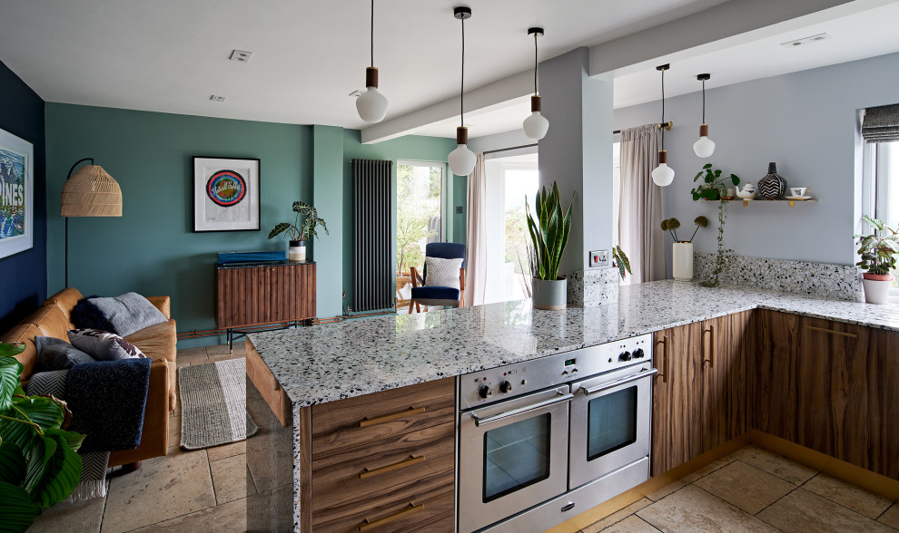 Design ideas for a large contemporary open plan kitchen in Wiltshire with a double-bowl sink, flat-panel cabinets, dark wood cabinets, terrazzo worktops, grey splashback, stainless steel appliances, a breakfast bar and grey worktops.