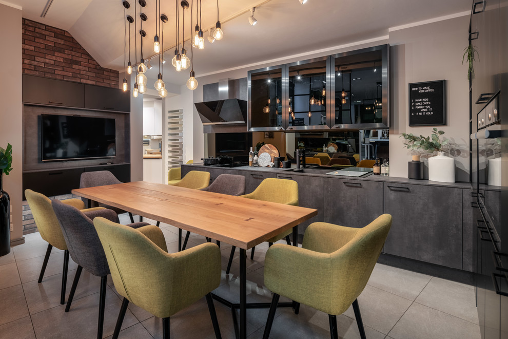 Inspiration for a contemporary l-shaped kitchen/diner in Other with an integrated sink, flat-panel cabinets, grey cabinets, mirror splashback, black appliances, no island, grey floors and grey worktops.
