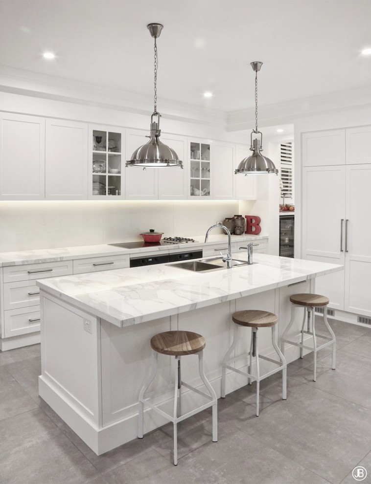 Inspiration for a modern kitchen pantry in Sydney with a double-bowl sink, shaker cabinets, white cabinets, marble worktops, white splashback, glass sheet splashback, stainless steel appliances, ceramic flooring, an island, grey floors and white worktops.