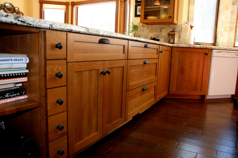 This is an example of a large rural u-shaped kitchen/diner in San Francisco with a submerged sink, shaker cabinets, light wood cabinets, granite worktops, beige splashback, cement tile splashback, white appliances, medium hardwood flooring and an island.