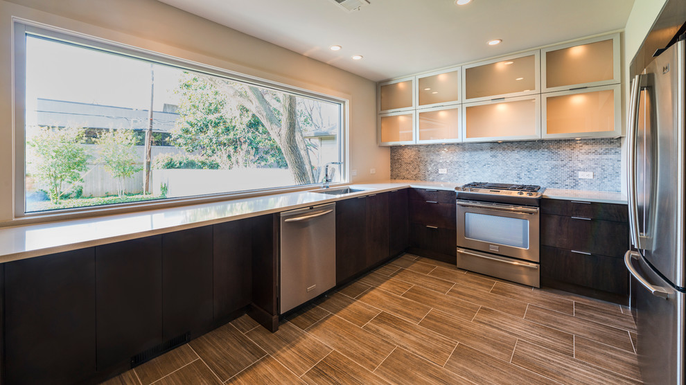Inspiration for a small modern u-shaped porcelain tile enclosed kitchen remodel in Other with a single-bowl sink, flat-panel cabinets, stainless steel cabinets, quartzite countertops, white backsplash, mosaic tile backsplash, stainless steel appliances and no island