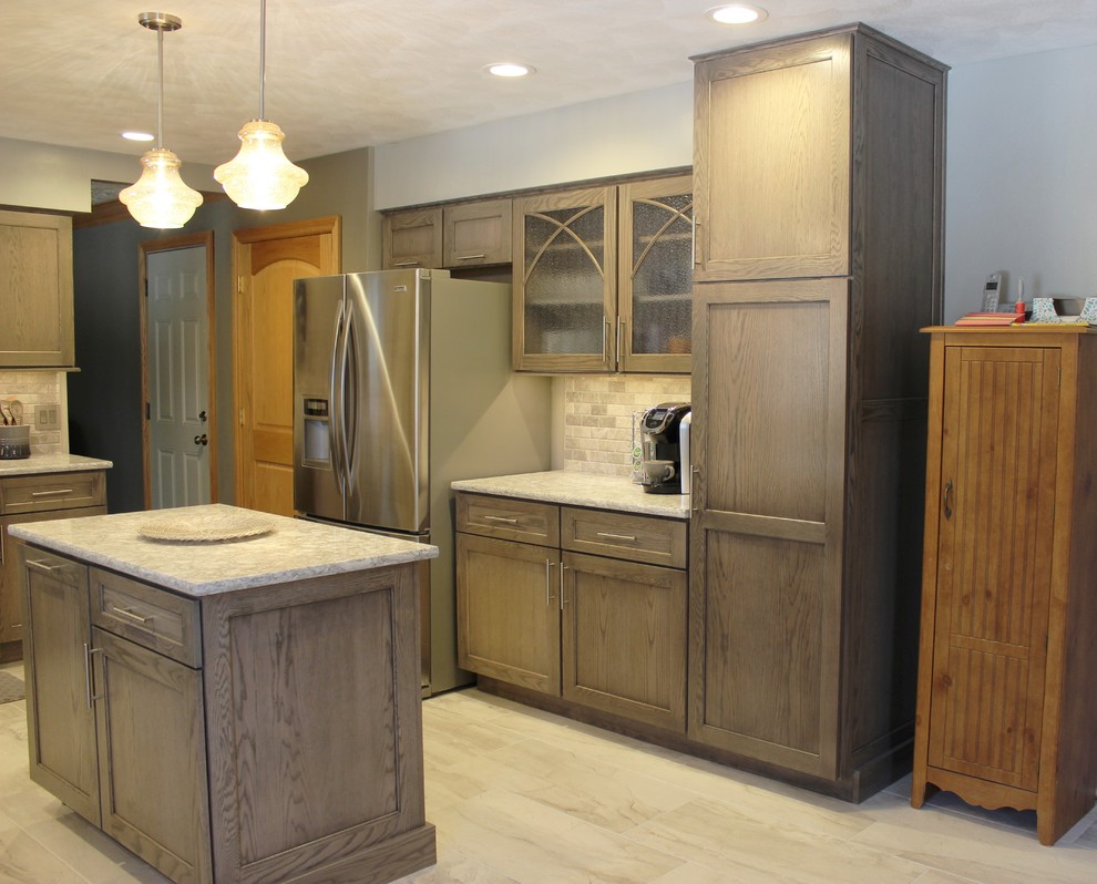 Example of a mid-sized classic u-shaped ceramic tile and gray floor eat-in kitchen design in Other with an undermount sink, flat-panel cabinets, gray cabinets, quartz countertops, gray backsplash, limestone backsplash, stainless steel appliances, an island and gray countertops