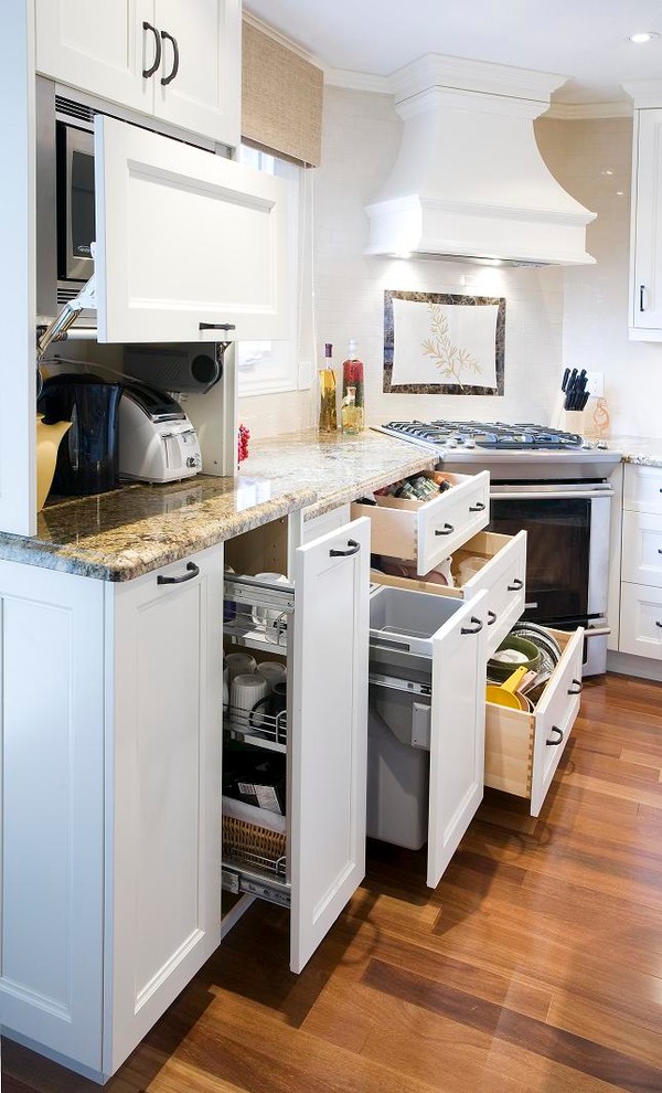 Example of a transitional kitchen design in Toronto with recessed-panel cabinets, white cabinets, white backsplash and stainless steel appliances