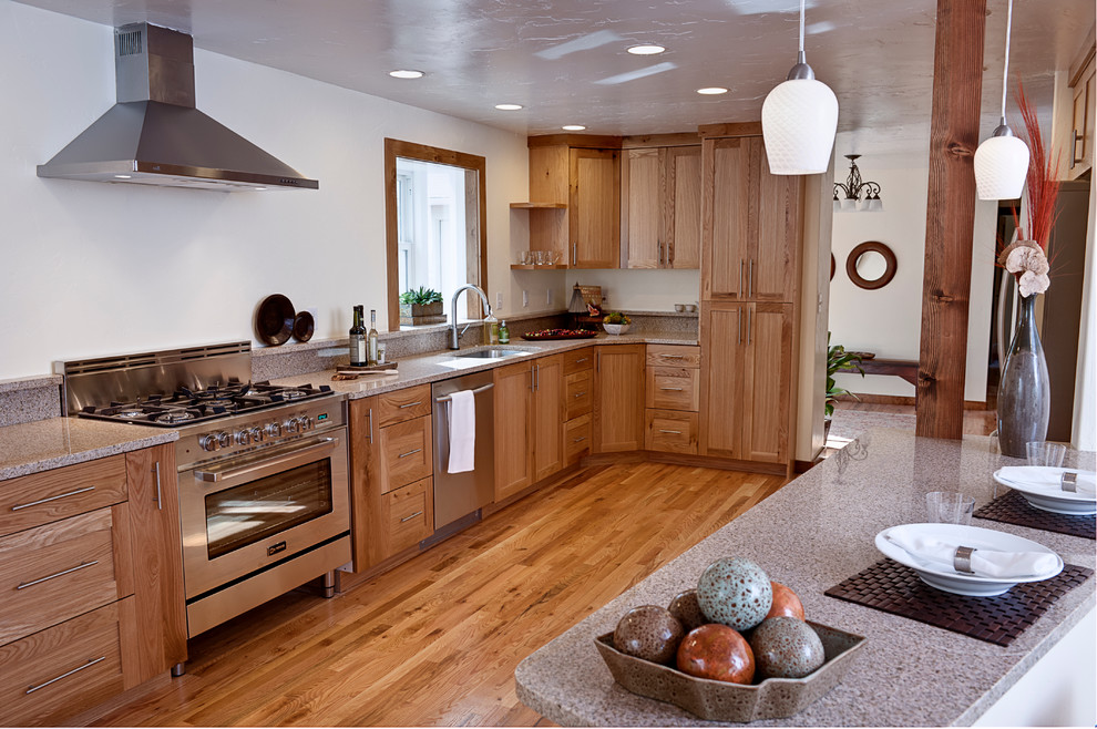 Eat-in kitchen - large traditional galley medium tone wood floor eat-in kitchen idea in Boise with an undermount sink, shaker cabinets, medium tone wood cabinets, laminate countertops, stainless steel appliances and an island