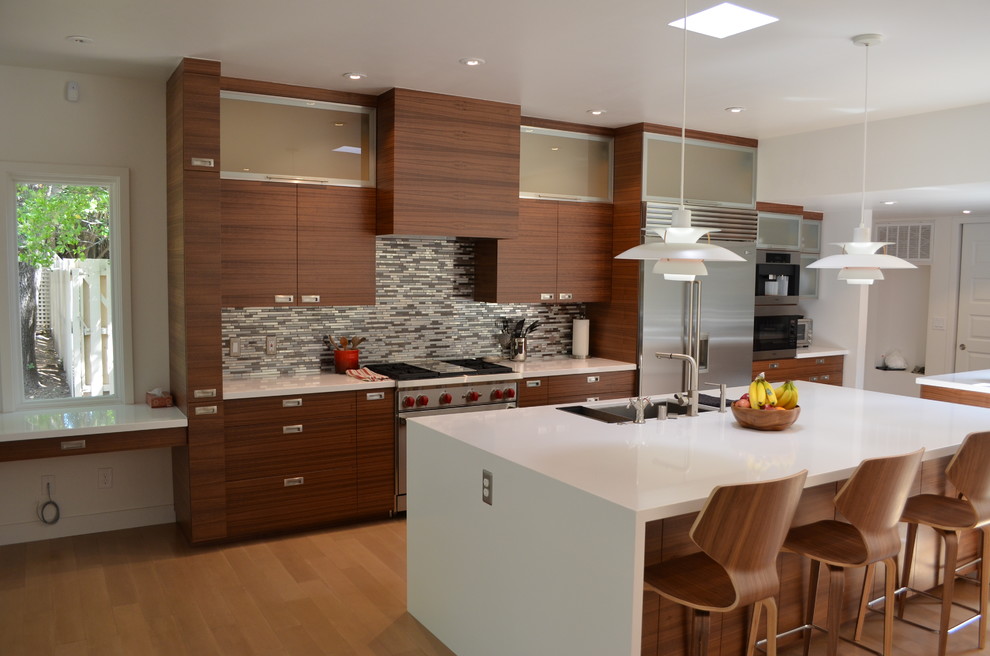 Example of a large minimalist galley light wood floor kitchen design in Sacramento with an undermount sink, flat-panel cabinets, multicolored backsplash, stainless steel appliances, an island, dark wood cabinets and matchstick tile backsplash