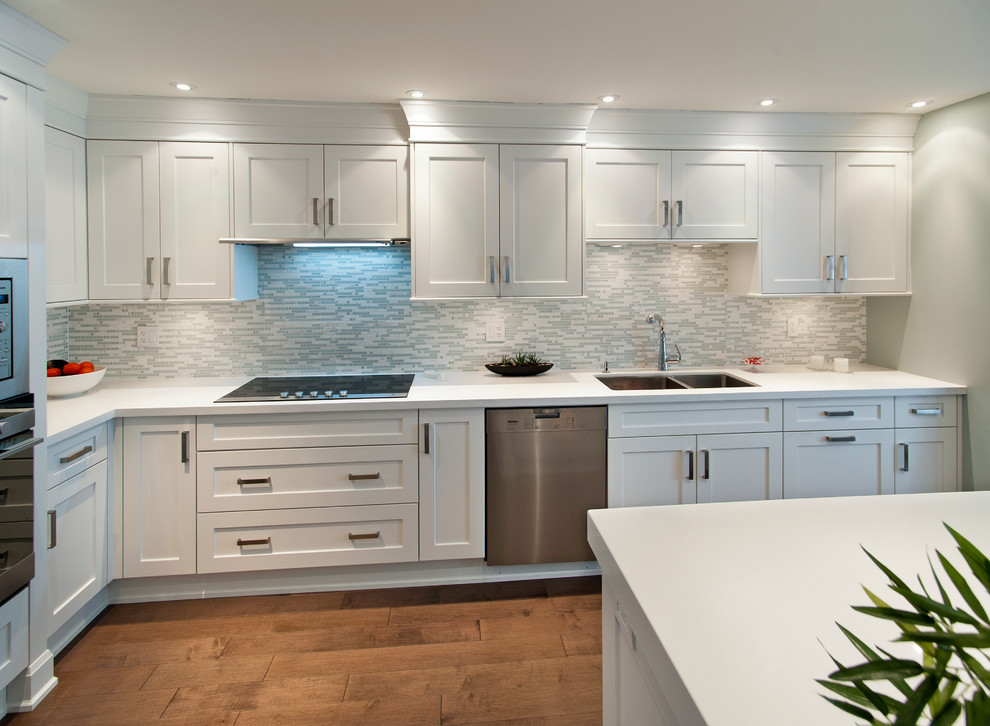 Classic l-shaped kitchen/diner in Vancouver with a submerged sink, flat-panel cabinets and white cabinets.