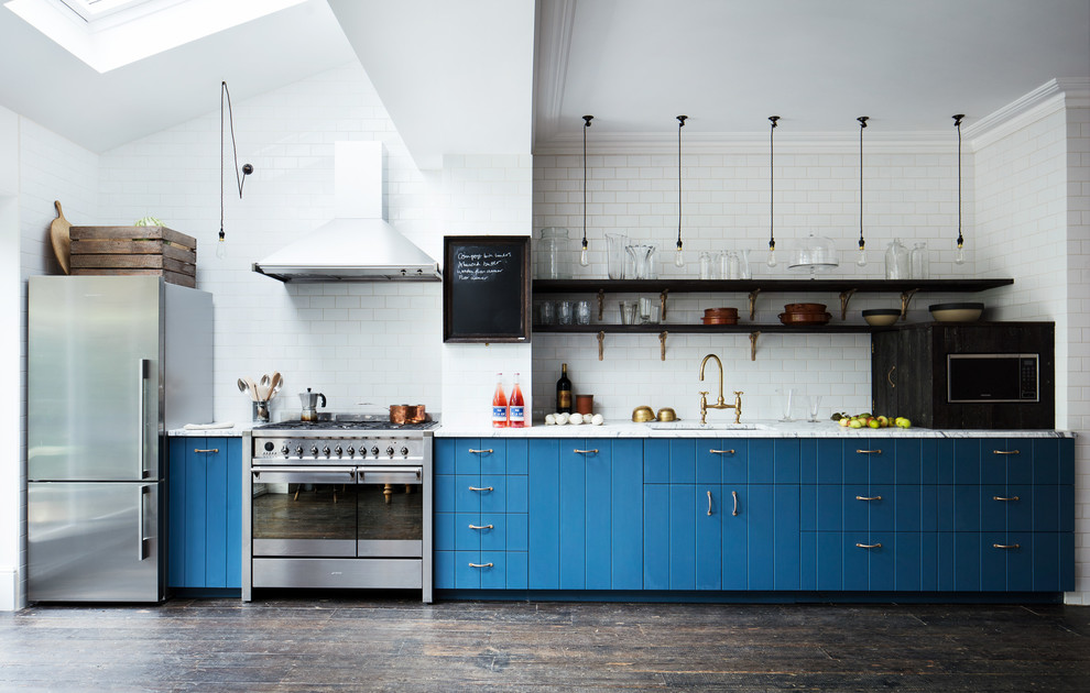 Photo of a large contemporary single-wall kitchen in London with a submerged sink, blue cabinets, marble worktops, white splashback, metro tiled splashback, stainless steel appliances, dark hardwood flooring, no island, brown floors, white worktops and flat-panel cabinets.