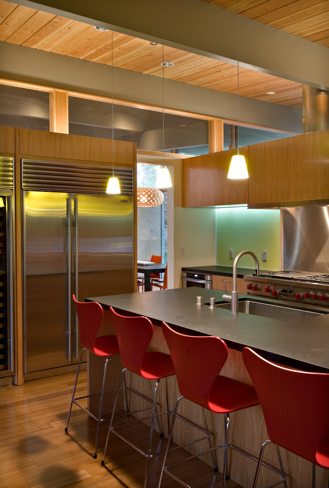 Photo of a contemporary kitchen in San Francisco with a submerged sink, flat-panel cabinets, medium wood cabinets, stainless steel appliances and an island.