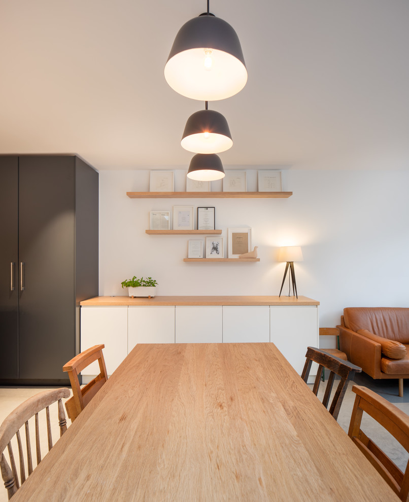 Photo of a large scandi kitchen/dining room in London with concrete flooring and grey floors.