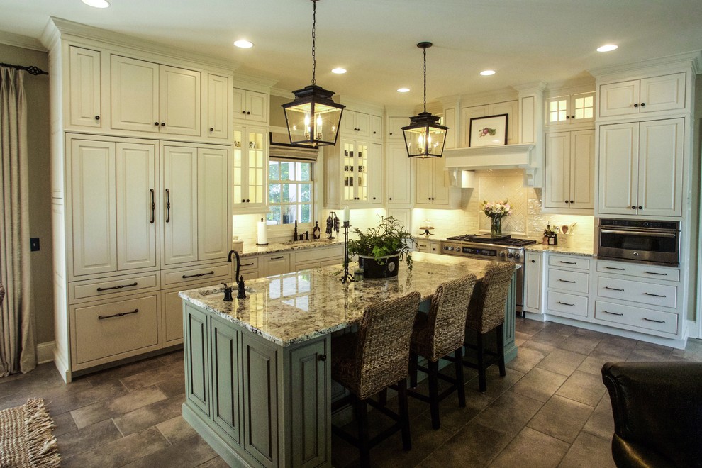 This is an example of a traditional kitchen in Other with beaded cabinets, white cabinets, stainless steel appliances and an island.