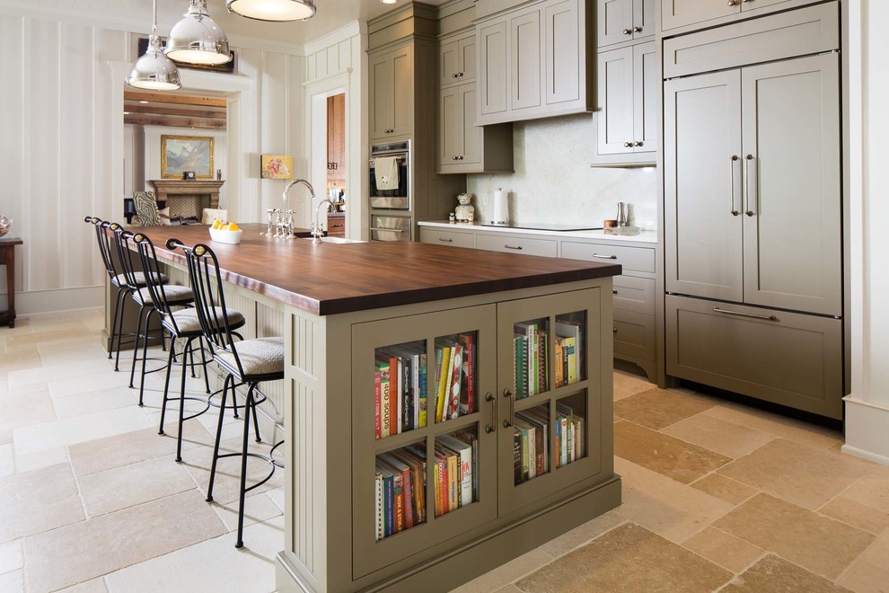 Inspiration for a large country kitchen in Nashville with a belfast sink, recessed-panel cabinets, green cabinets, wood worktops, stainless steel appliances, an island, beige floors and slate flooring.
