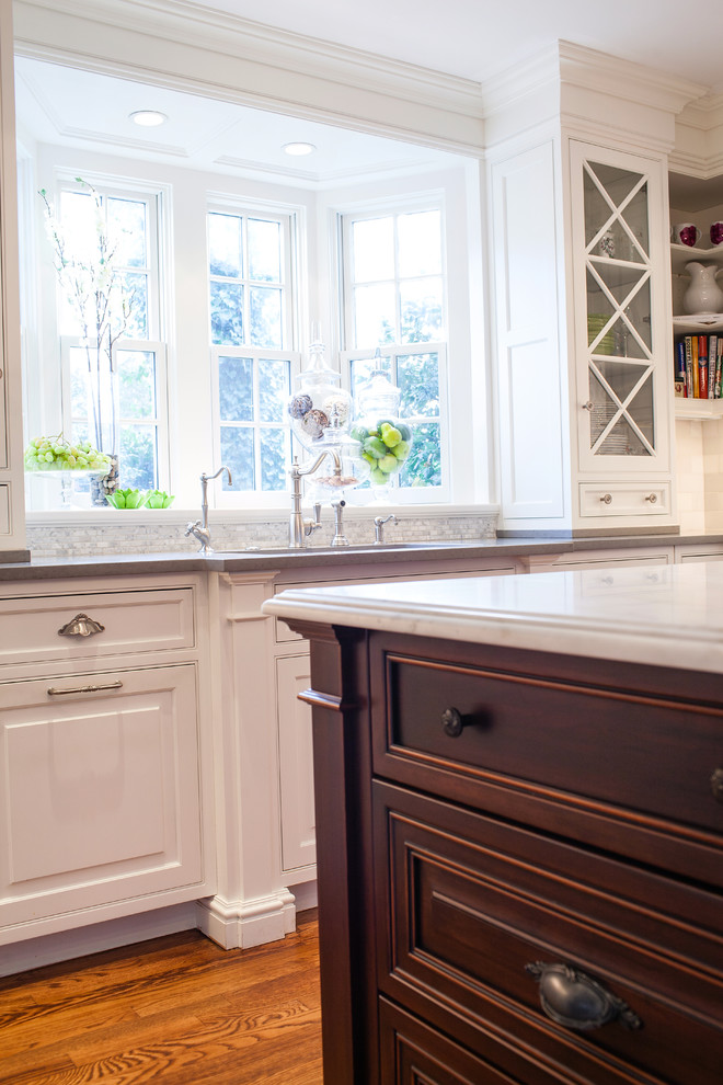 Example of a classic u-shaped eat-in kitchen design in Newark with an undermount sink, beaded inset cabinets and white cabinets