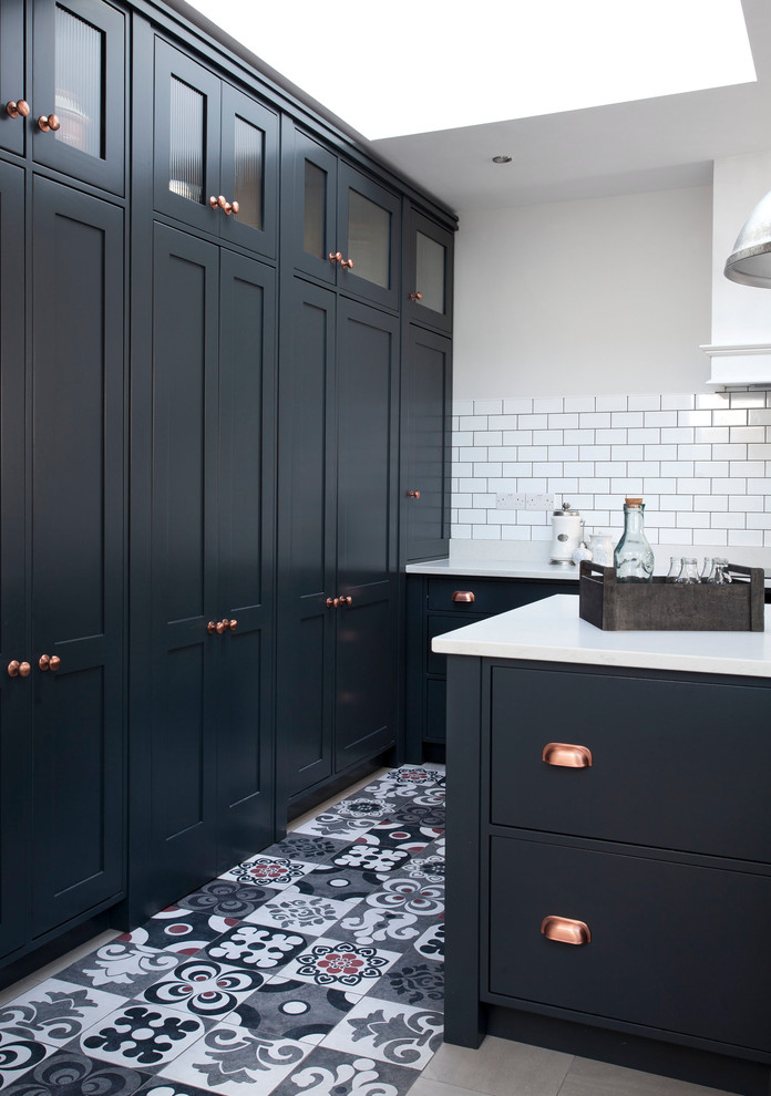 Inspiration for a traditional kitchen in Other with a built-in sink, shaker cabinets, blue cabinets, quartz worktops, white splashback, ceramic splashback, stainless steel appliances, ceramic flooring and an island.