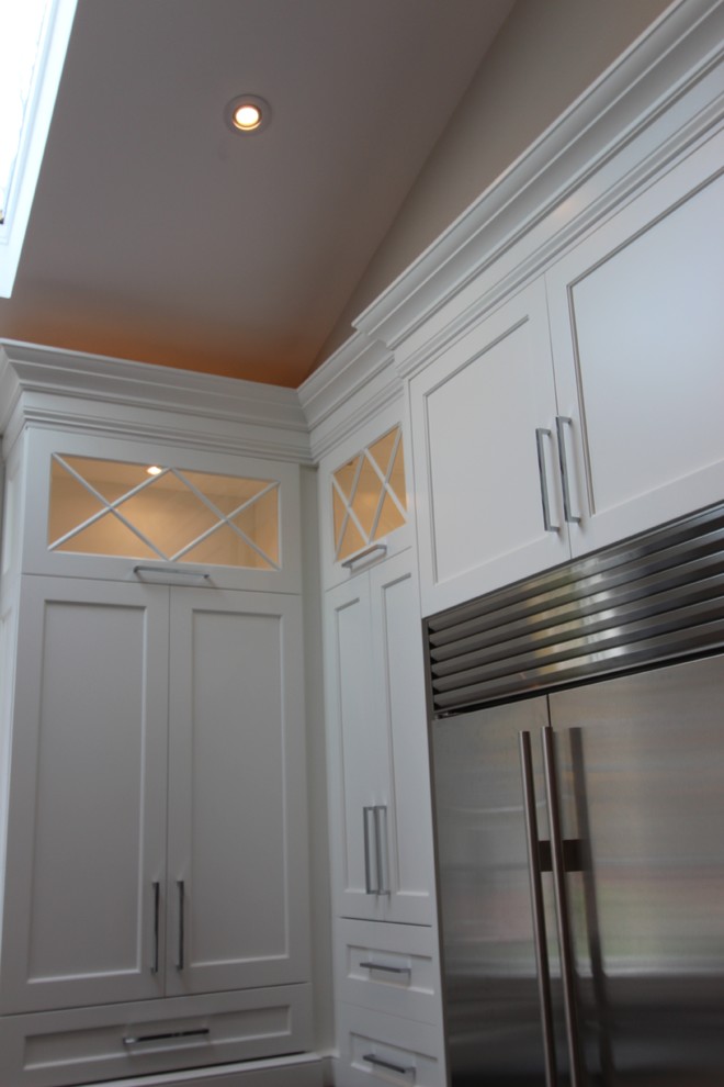Idéer för ett modernt kök, med en rustik diskho, luckor med infälld panel, vita skåp, marmorbänkskiva, grått stänkskydd, rostfria vitvaror, mörkt trägolv och flera köksöar