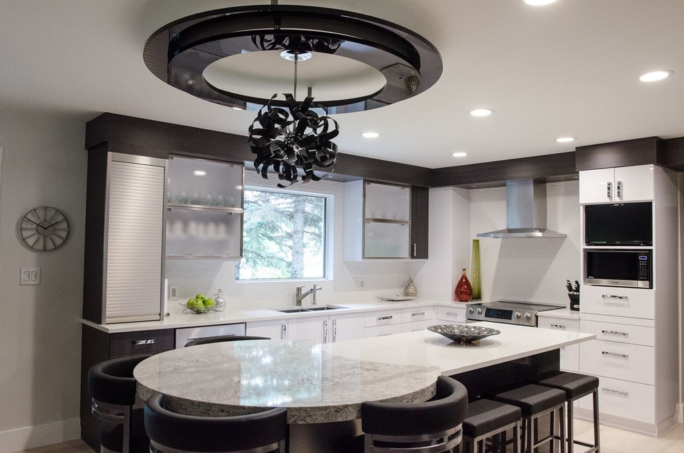 This is an example of a large contemporary l-shaped kitchen/diner in Orange County with a double-bowl sink, flat-panel cabinets, white cabinets, quartz worktops, white splashback, mosaic tiled splashback, stainless steel appliances, porcelain flooring and an island.