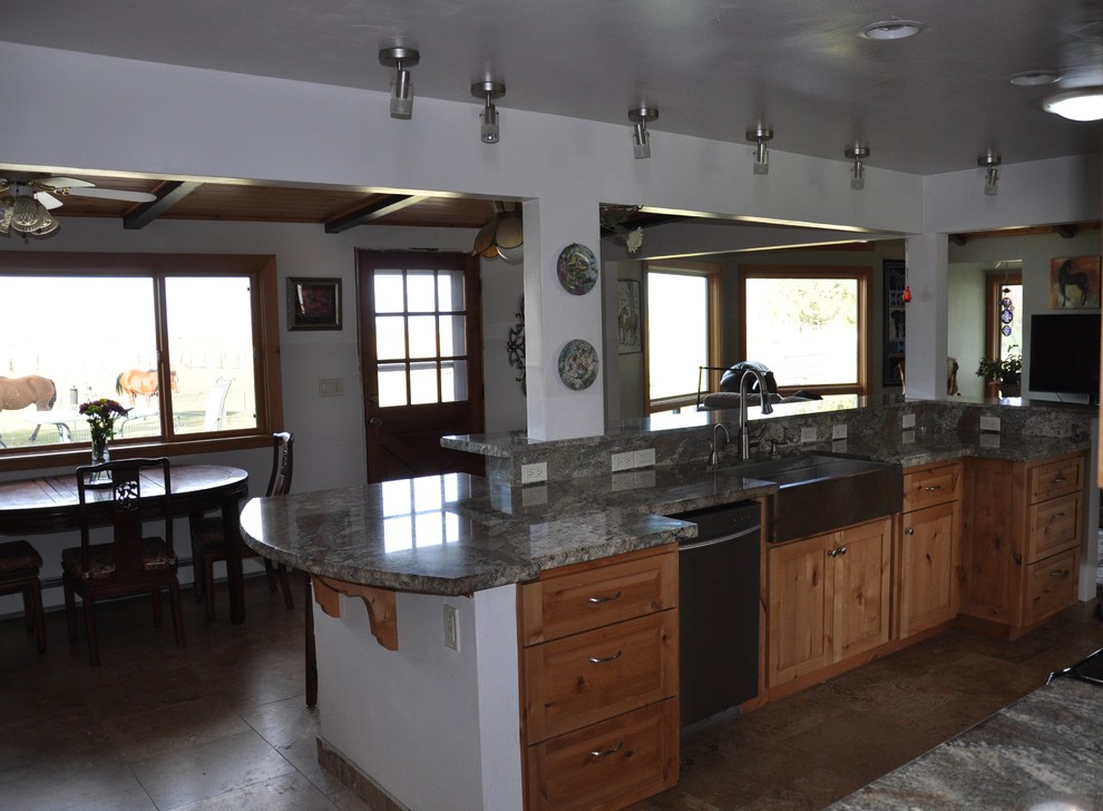 Inredning av ett lantligt mellanstort kök, med en rustik diskho, luckor med upphöjd panel, skåp i mörkt trä, granitbänkskiva, grått stänkskydd, stänkskydd i stenkakel, rostfria vitvaror, klinkergolv i keramik, flera köksöar och brunt golv