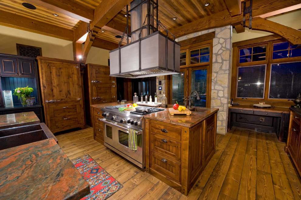Inspiration for a huge rustic l-shaped medium tone wood floor open concept kitchen remodel in Vancouver with a farmhouse sink, shaker cabinets, medium tone wood cabinets, granite countertops, stainless steel appliances and two islands