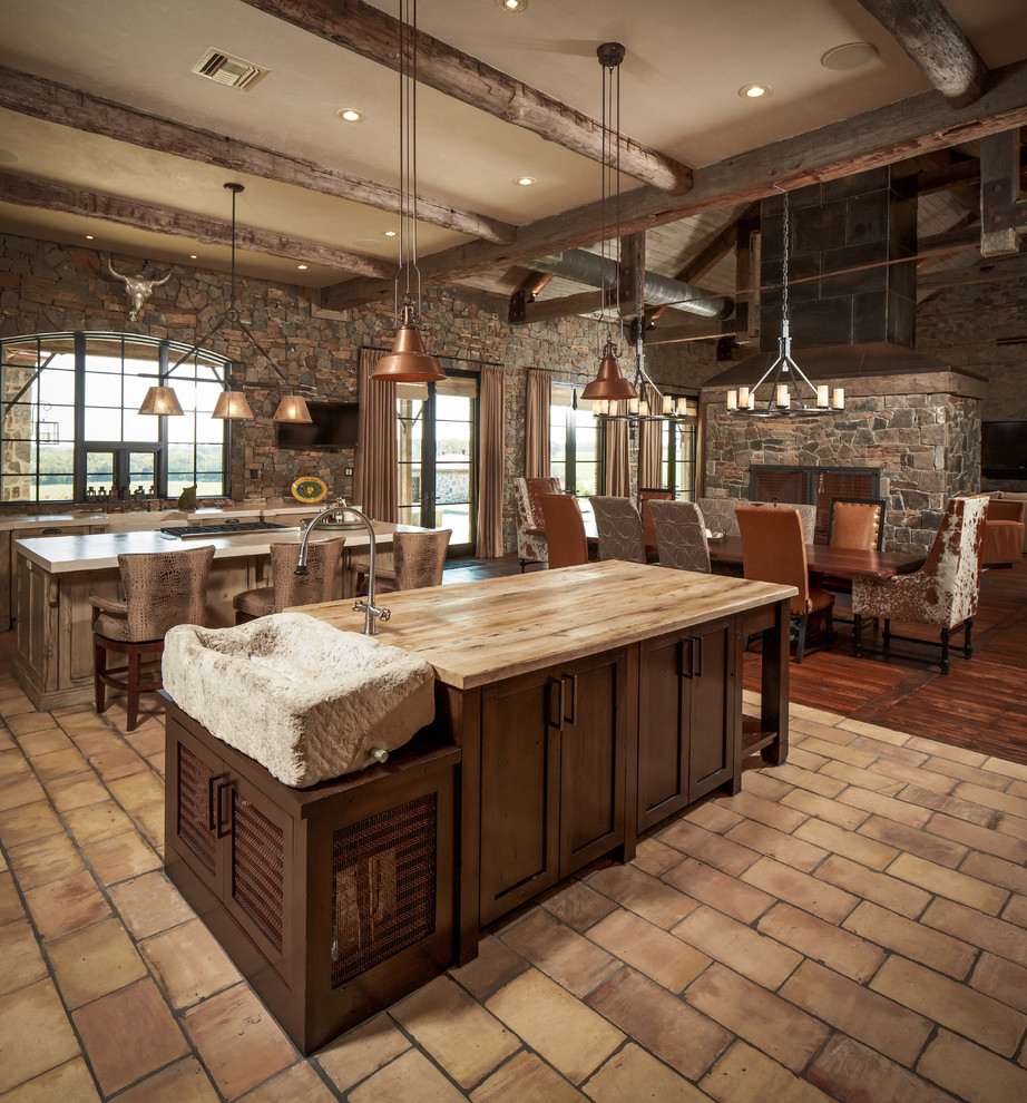 Inspiration for a large rustic l-shaped brick floor and beige floor open concept kitchen remodel in Houston with dark wood cabinets, a drop-in sink, shaker cabinets, wood countertops, multicolored backsplash, brick backsplash and two islands