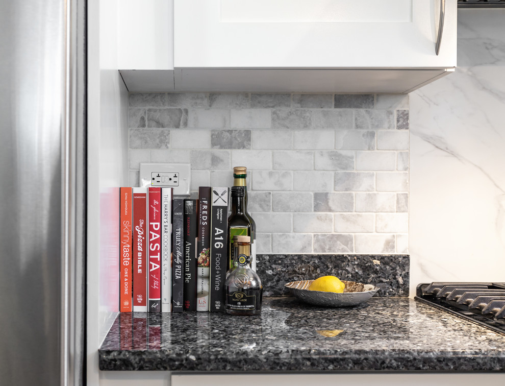 Modern inredning av ett mellanstort svart svart kök, med en undermonterad diskho, skåp i shakerstil, vita skåp, granitbänkskiva, flerfärgad stänkskydd, stänkskydd i keramik, rostfria vitvaror, mellanmörkt trägolv och en köksö