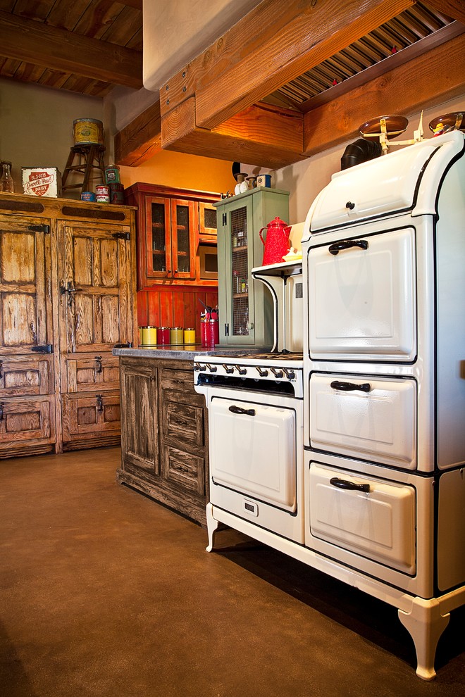 This is an example of a small rustic single-wall kitchen pantry in Orange County with glass-front cabinets, distressed cabinets and no island.