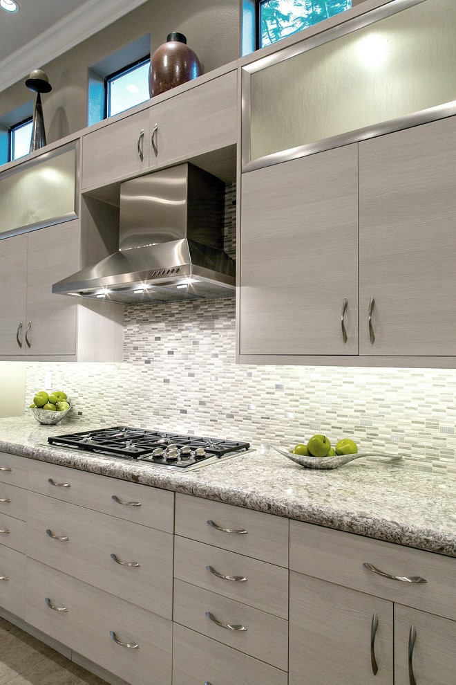 Design ideas for a large contemporary l-shaped kitchen in Other with a submerged sink, flat-panel cabinets, grey cabinets, quartz worktops, grey splashback, glass tiled splashback, stainless steel appliances, ceramic flooring, an island and beige floors.