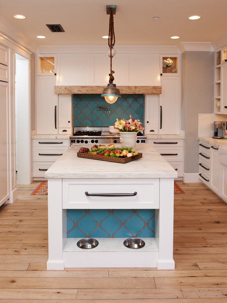 Kitchen - mediterranean u-shaped kitchen idea in San Diego with white cabinets, marble countertops, white backsplash and white countertops
