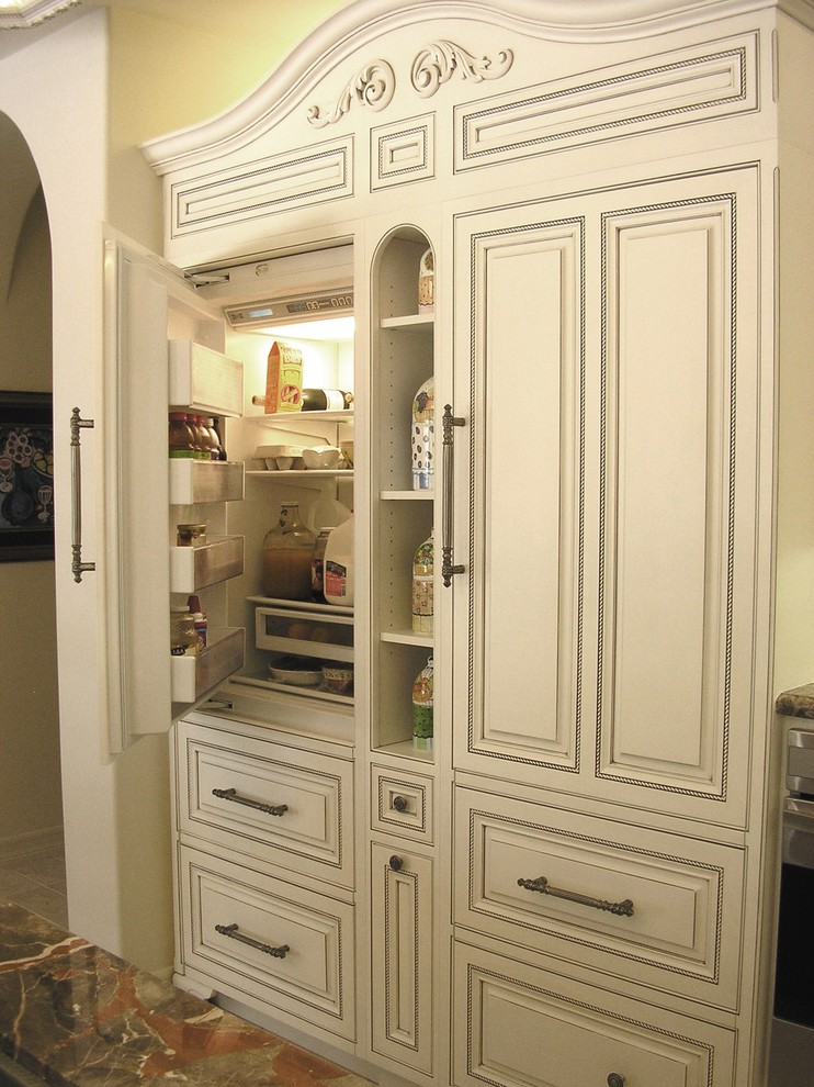 Inspiration for a large timeless u-shaped ceramic tile and beige floor open concept kitchen remodel in San Diego with a farmhouse sink, beaded inset cabinets, beige cabinets, marble countertops, beige backsplash, mosaic tile backsplash, stainless steel appliances and an island
