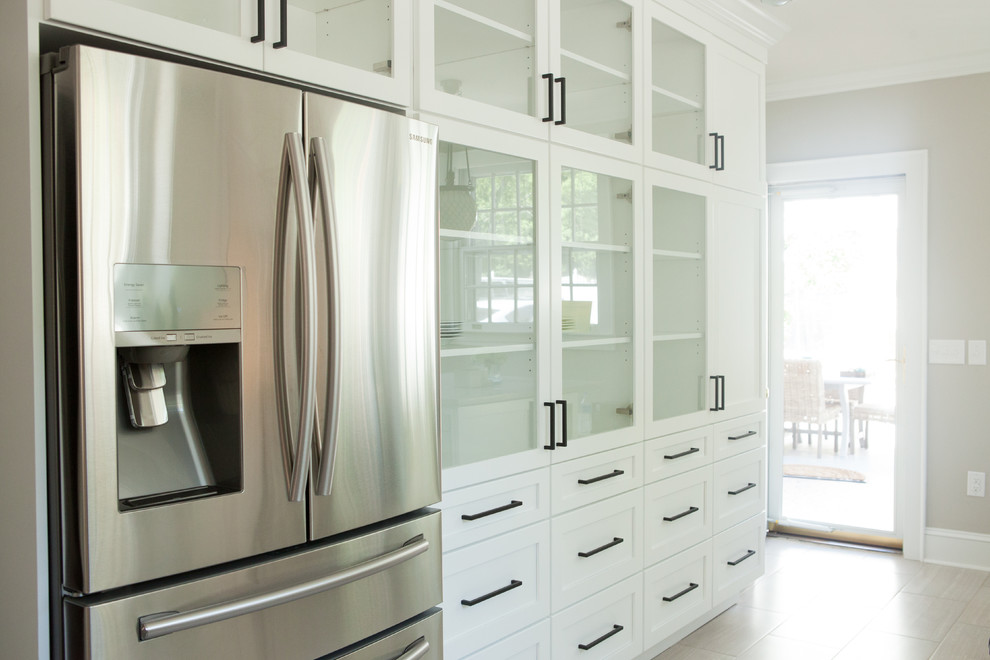 Example of a farmhouse kitchen design in Charlotte with an island
