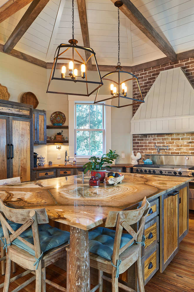 Example of a farmhouse medium tone wood floor kitchen design in Atlanta with recessed-panel cabinets, medium tone wood cabinets, an island and paneled appliances
