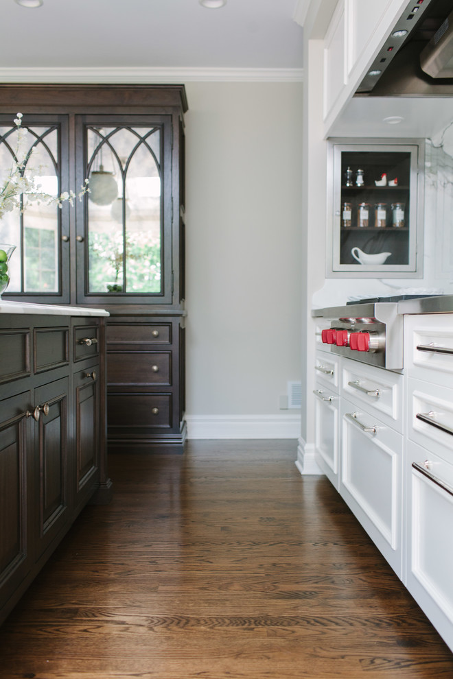 Eat-in kitchen - large transitional galley dark wood floor eat-in kitchen idea in Chicago with an undermount sink, beaded inset cabinets, white cabinets, marble countertops, white backsplash, stone slab backsplash, stainless steel appliances and an island