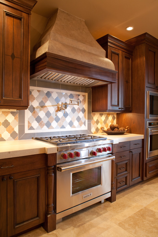 Foto de cocina actual con armarios con paneles empotrados, puertas de armario de madera en tonos medios, salpicadero multicolor y electrodomésticos de acero inoxidable