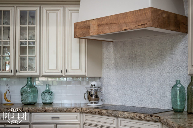 A custom white range hood is accented with reclaimed wood planks.