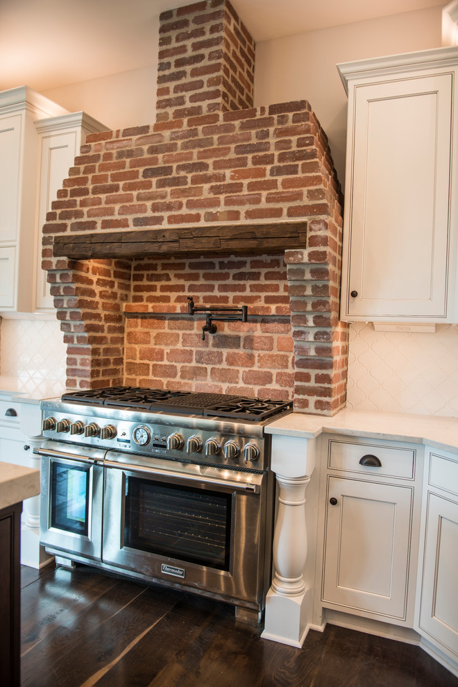 Range with brick and reclaimed beam hood - Farmhouse ...