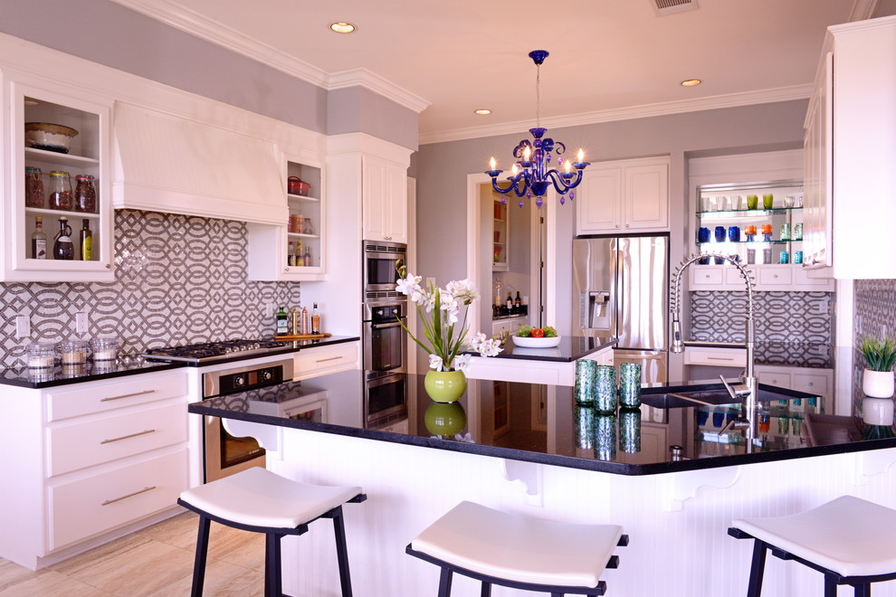 Contemporary kitchen in Austin with a double-bowl sink, white cabinets and stainless steel appliances.