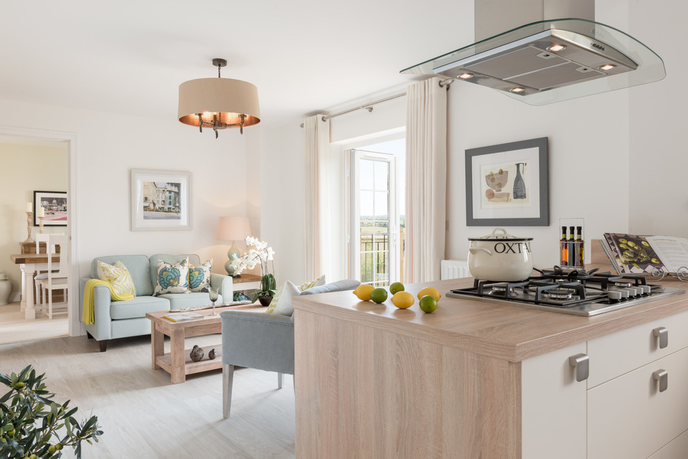 Inspiration for a medium sized contemporary open plan kitchen in London with flat-panel cabinets, light wood cabinets, wood worktops, light hardwood flooring and an island.