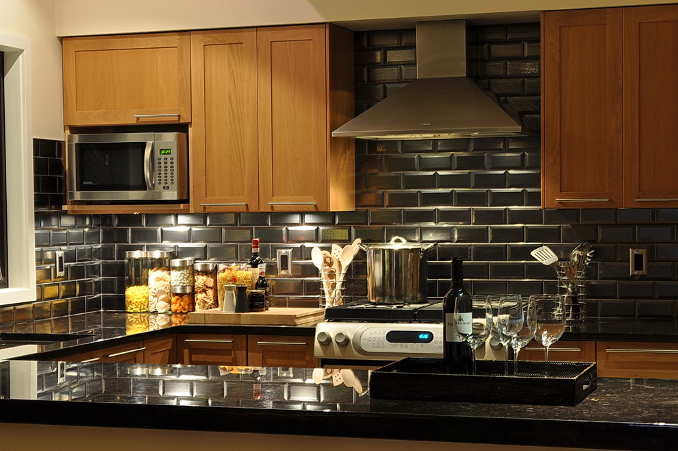 Kitchen - contemporary kitchen idea in Vancouver with an undermount sink, shaker cabinets, medium tone wood cabinets, black backsplash, subway tile backsplash and stainless steel appliances