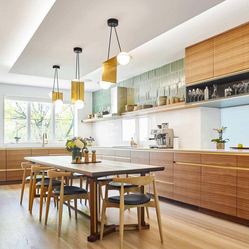 Design ideas for a contemporary l-shaped kitchen/diner in Toronto with flat-panel cabinets, medium wood cabinets, white splashback, stone slab splashback, light hardwood flooring, beige floors and white worktops.