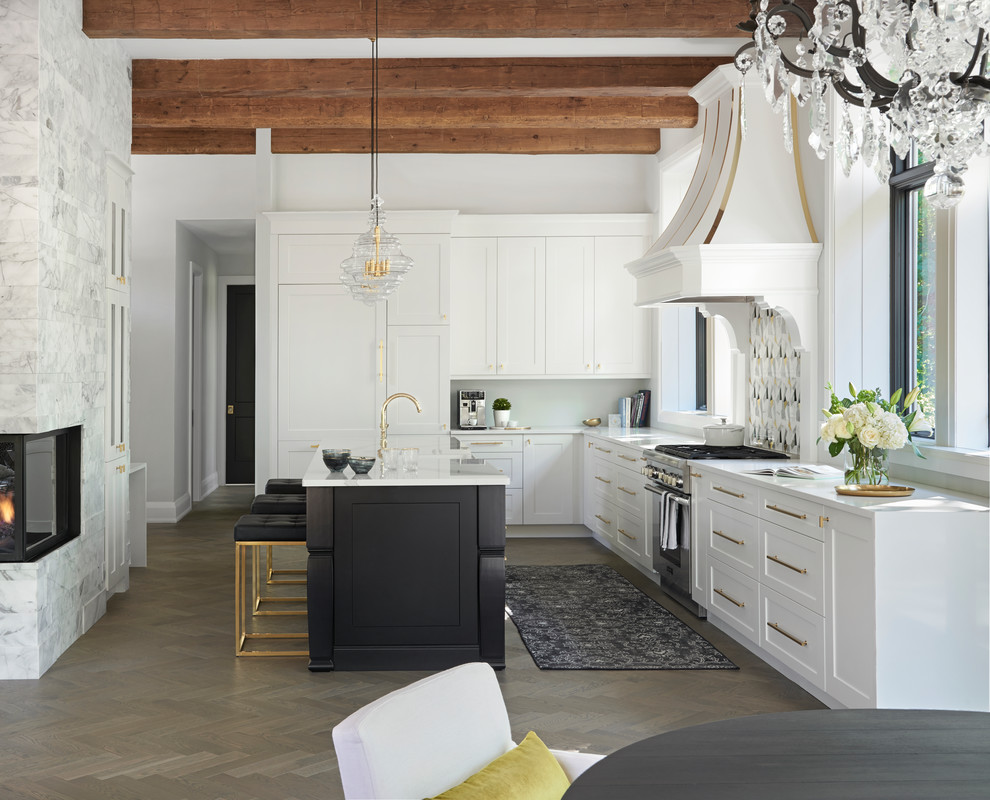 Example of a transitional l-shaped medium tone wood floor and gray floor eat-in kitchen design in Toronto with an undermount sink, recessed-panel cabinets, white cabinets, white backsplash, stainless steel appliances, an island and white countertops