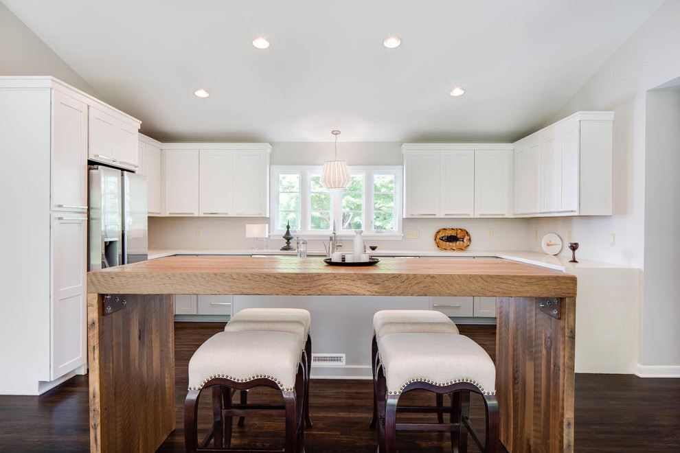 Design ideas for a traditional u-shaped kitchen/diner in Columbus with shaker cabinets, white cabinets and dark hardwood flooring.